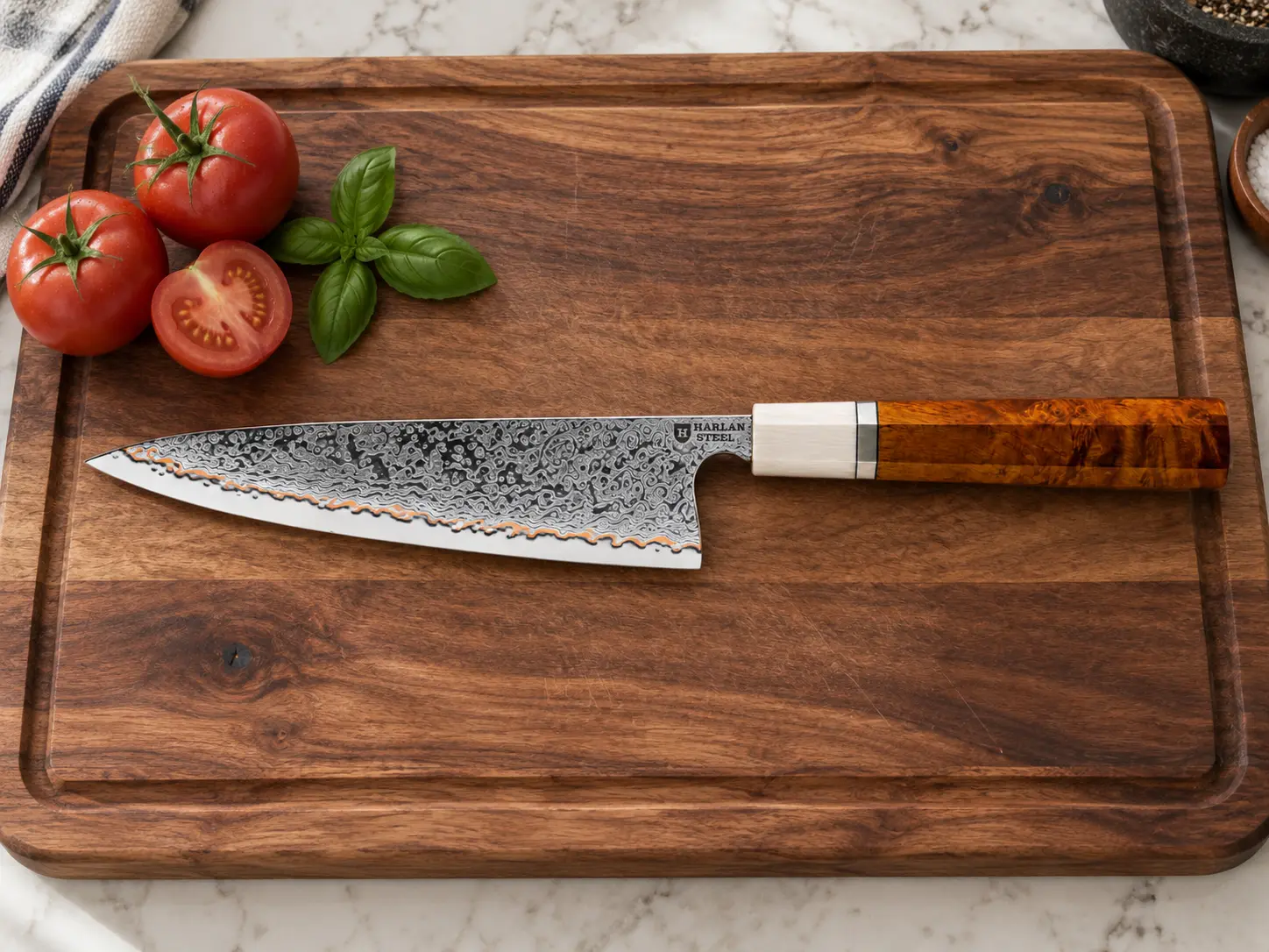 Harlan Steel Light copper Damascus kitchen knife on a wooden board with tomatoes and basil.